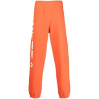 heron preston pantalon de jogging à logo imprimé - orange