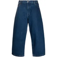 studio nicholson jean ample à coupe courte - bleu
